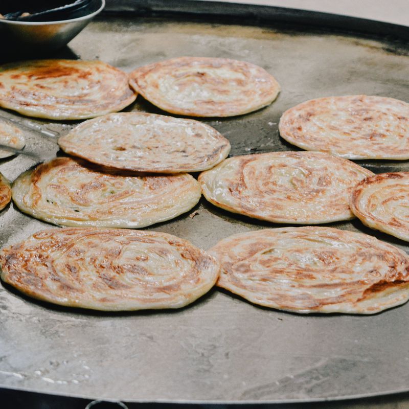 Live parotta cooking on the griddle